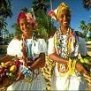 Two people wearing colorful beads and jewelry